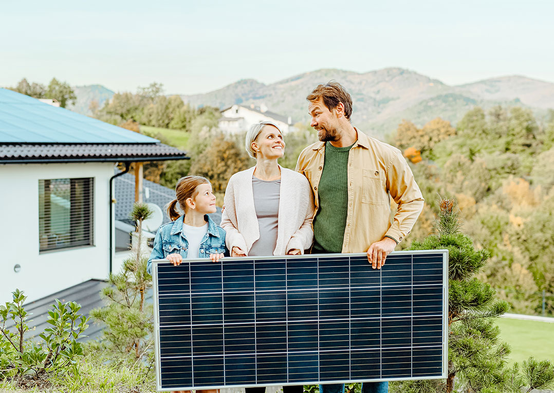 Paul Energie Ihre eigene Solaranlage - Glückliche Familie hält Papiermodell eines Hauses mit Sonnenkollektoren. Alternative Energie, Ressourcen sparen